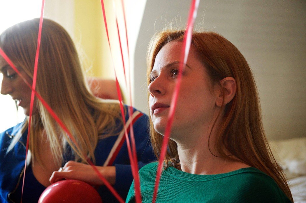 Pippa (Jessica Greco) makes a wish on a balloon with Alice (Hannah Cheesman) in The Animal Project | Photo by John Gundy.